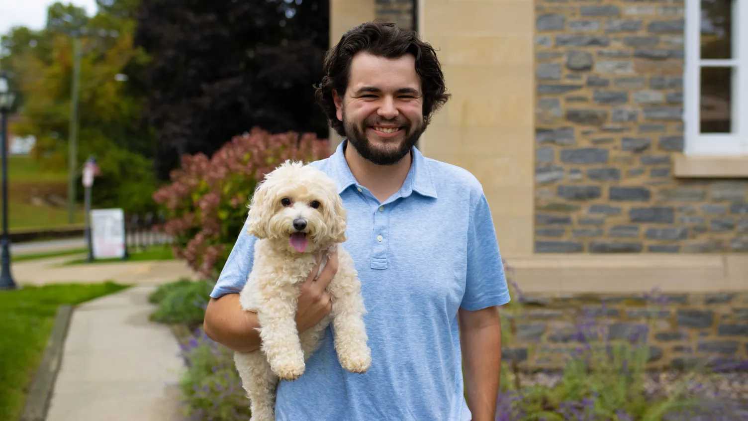Essex Bank customer Trey Neubert and his dog