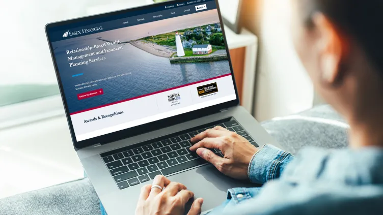 Laptop with the Essex Financial website on screen