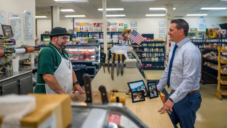 Essex Bank officer with Frank Serio of Cliff's Quality Meats