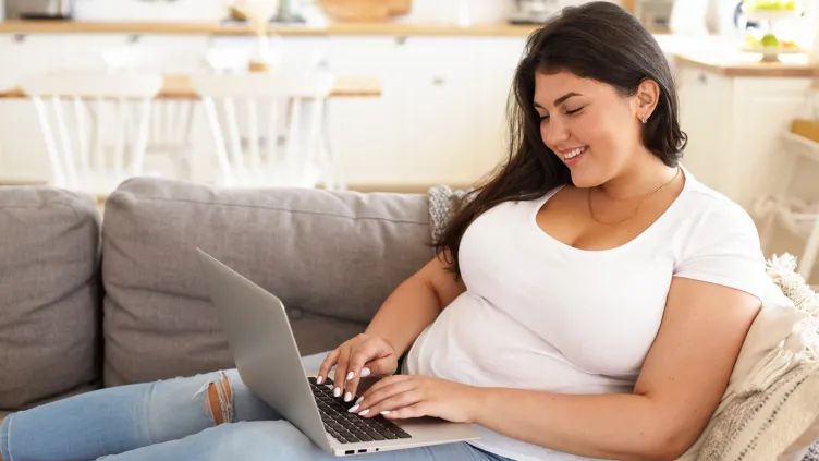 Woman with laptop on couch